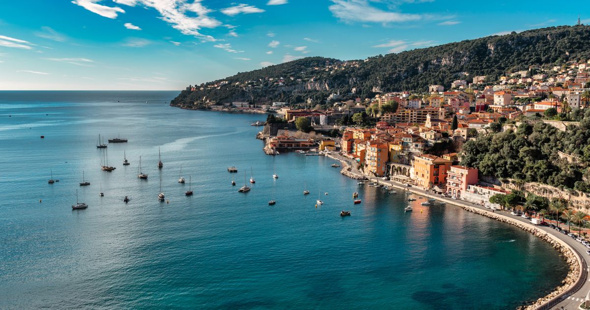 A luxury yacht sailing on the clear blue waters of the Mediterranean.